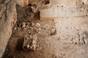 Archaeological excavations. Human remains in the ground, with many artefacts found in the tomb. Real digger process. Outdoors at Ban Pong Manao Archeological Site, Lopburi, Thailand.