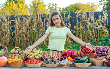 A child at a farmers market with vegetables. Selective focus.