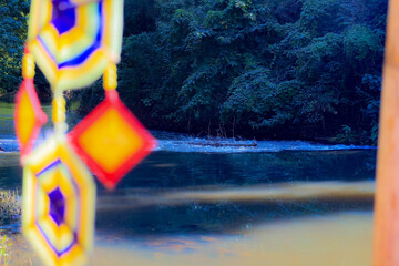 This is a Spider Web Tung, a traditional Lanna flag made of threads, used for religious ceremonies.