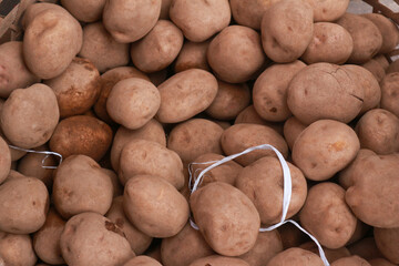 Fresh potatoes in a traditional market pile ready for sale