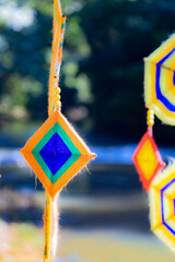 This is a Spider Web Tung, a traditional Lanna flag made of threads, used for religious ceremonies.