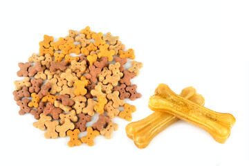 Assorted Bone Shaped Dog Treats and Large Rawhide Bones on White Background