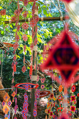 This is a Spider Web Tung, a traditional Lanna flag made of threads, used for religious ceremonies.