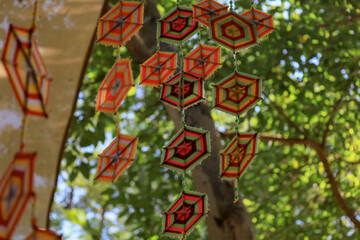 This is a Spider Web Tung, a traditional Lanna flag made of threads, used for religious ceremonies.