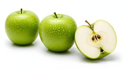 Three fresh green apples on white background&mdash;two whole with water droplets, one sliced to reveal juicy interior, symbolizing health, freshness, and natural nutrition.