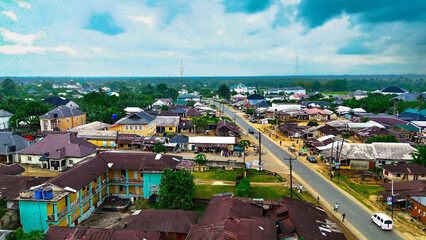 Aerial view of rooftops and roads interwoven with lush greenery, painting a vibrant tapestry of urban life, Isiokpo, Rivers, Nigeria.