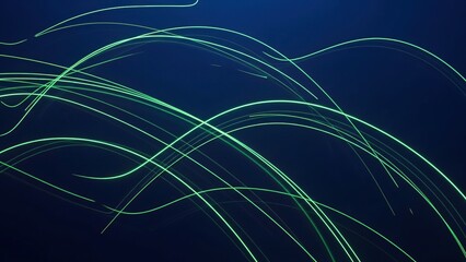 Green light trails on a dark blue background with abstract lines and curves