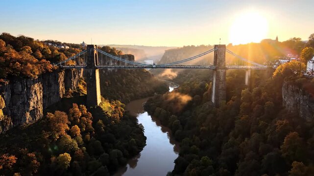 Majestic Clifton Suspension Bridge spanning the Avon Gorge at golden hour sunrise.