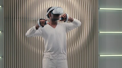 Futurism African American man using VR technology in futuristic space male guy using metaverse multimedia standing holding controllers moving hands gaming discovery future cyberspace virtual reality