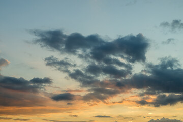 The sky is filled with clouds and the sun is setting