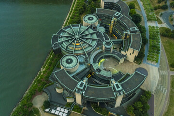 Aerial view of the Landtag of North Rhine-Westphalia reflecting in the river, a symphony of green and grey tones, Dusseldorf, North Rhine-Westphalia, Germany.