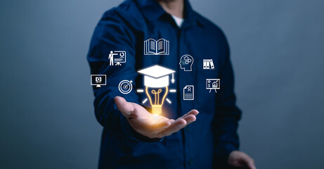 concept of online education courses or e-learning technology, man's hand displaying a virtual light bulb and graduation cap, acquiring knowledge through internet technology, modern learning