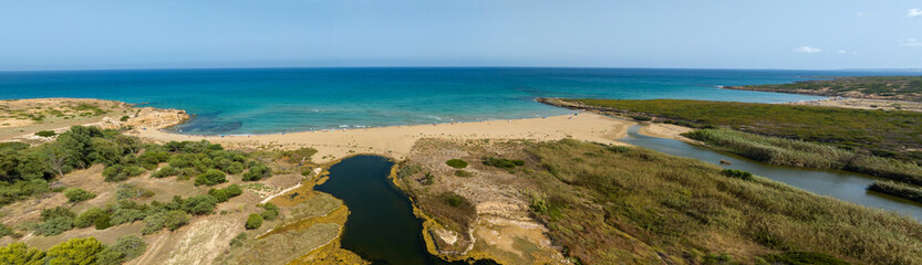 Panoramic aerial view of Eloro Beach, located in the northern part of the Vendicari Reserve, in the province of Syracuse, Sicily, Italy. It is a beautiful sandy beach overlooking a crystalline sea.