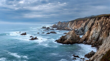 Dramatic Coastal Cliffs Meet Turquoise Ocean Waves Under Moody Skies.