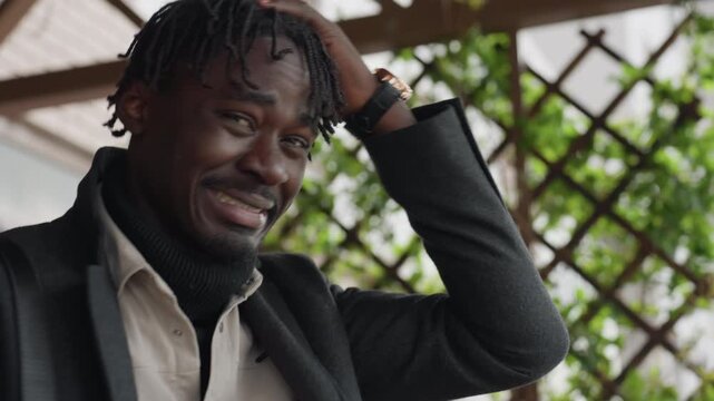 Modern youth in three layered clothes raises hand to head, checks watch, grimaces over lost time, quick steps through corridor, winter style, urgency mood emphasizing stress and countdown feeling