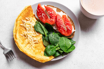 Healthy breakfast. Omelette, sandwich with salmon, spinach.