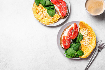 Healthy breakfast for two. Omelette, sandwich with salmon, spinach.