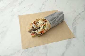 Beef shawarma with yogurt and cucumber sauce, served with a side of spiced rice and steamed...