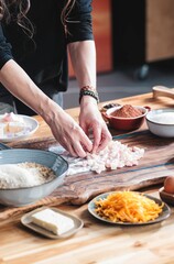 Hands skillfully prepare ingredients for Kozonac, a Balkan sweet bread featuring a delicate swirl of walnut and cocoa. The kitchen is filled with the warmth of tradition and holiday spirit