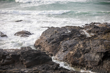 Waves crashing on the rocks at Godrevy Beach in Cornwall UK.