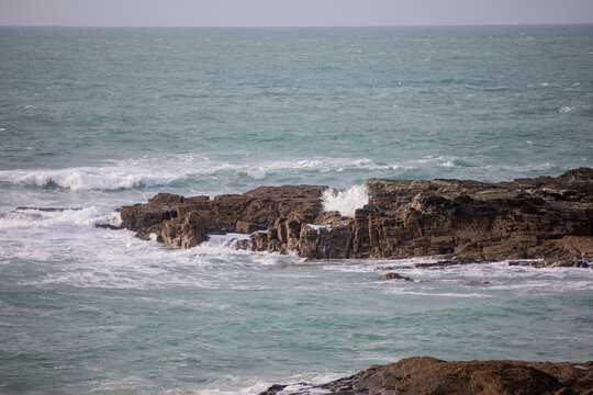 Waves crashing on the rocks at Godrevy Beach in Cornwall UK.