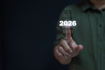 Man's hand pointing and touching the year 2026 on a virtual timeline interface. Concept of future...
