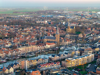 Obraz premium Aerial drone view of Harlingen old town and harbour at sunset 
