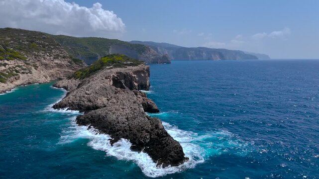 4K Cinematic Drone Video of Alitzerini Cave and Rugged Peninsula in Zakynthos, Greece, Surrounded by Turquoise Ionian Sea and Lush Coastal Hills