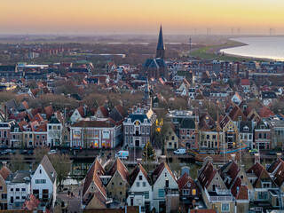 Naklejka premium Aerial drone view of Harlingen historic town at sunset