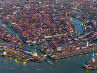Obraz premium Aerial drone view of Harlingen harbour and coastline at dusk