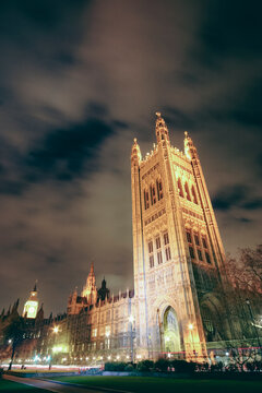 Victoria Tower at night in London. The Palace of Westminster's Victoria Tower illuminated under a dark cloudy sky in London.