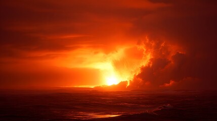 Fiery orange sunset illuminates dramatic storm clouds over dark ocean waters