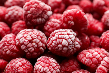Frozen ripe raspberries as background, closeup view