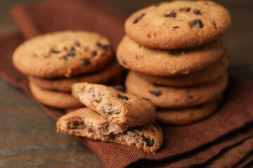 Yummy chocolate chip cookies on wooden table, closeup