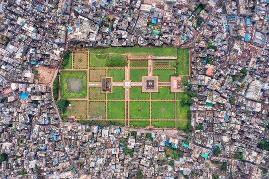 Aerial view of Lalbagh Fort's vibrant green gardens contrasting with the surrounding dense urban sprawl, Dhaka, Dhaka Division, Bangladesh.