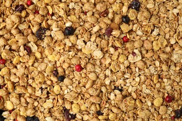 Tasty granola with dried fruits as background, top view