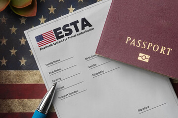 Esta application form with passport and pen on american flag background