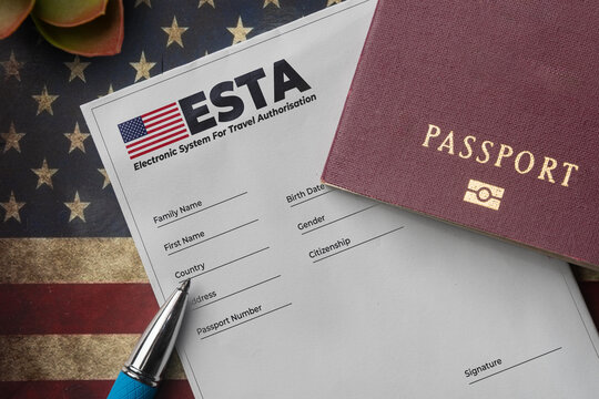 Esta application form with passport and pen on american flag background
