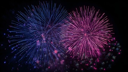 Obraz premium Brilliant blue and magenta pyrotechnic bursts illuminate a dark night sky