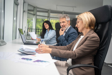 A group of business people partners during a set team meeting in the modern office.