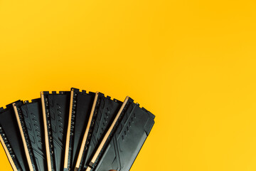 Fan arrangement of DDR RAM modules on yellow background with copy space. High quality photo