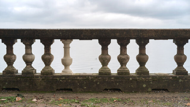 Vintage stone balustrade with some missing balusters, selective focus
