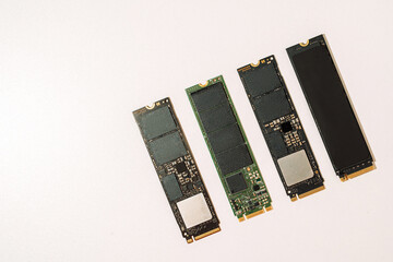 Set of M.2 NVMe SSD drives arranged diagonally on white background. High quality photo