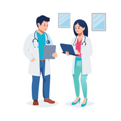 Male And Female Doctors Having Informal Meeting In Modern Hospital Looking At Digital Tablet