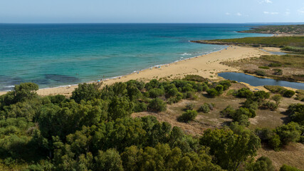 Aerial view of Eloro Beach, located in the northern part of the Vendicari Reserve, in the province of Syracuse, Sicily, Italy. It is a beautiful sandy beach overlooking a crystalline sea. Sunny day.