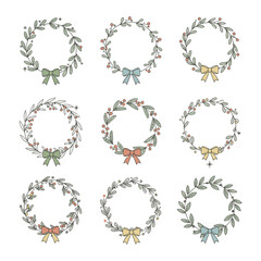 Set of nine hand drawn christmas wreaths with bows and berries on white background