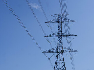 A tall electric tower against a clear blue sky
