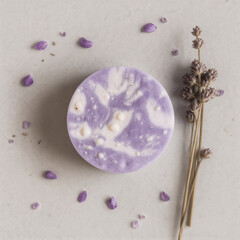 Round soap with lavender petals and flowers on gray background. Skincare and aromatherapy. Handmade soap from lavender 