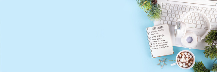 2026 Goals New Year resolution concept. Planning new year goals, bright colorful background with laptop, headphones, Christmas tree, hot chocolate mug and notebook with plan and goal list