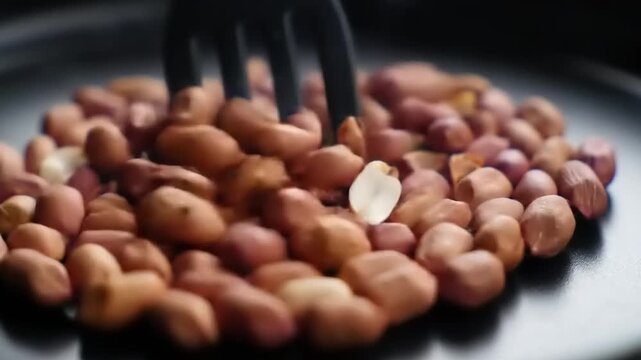 Close-up Macro Shot of Raw Peanuts on a Dark Plate.